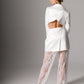 Chic bridal suit with lace pants and an elegant tailored blazer with cutout details