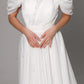 Dreamy off-shoulder wedding gown with puff sleeves and shimmering pearl accents