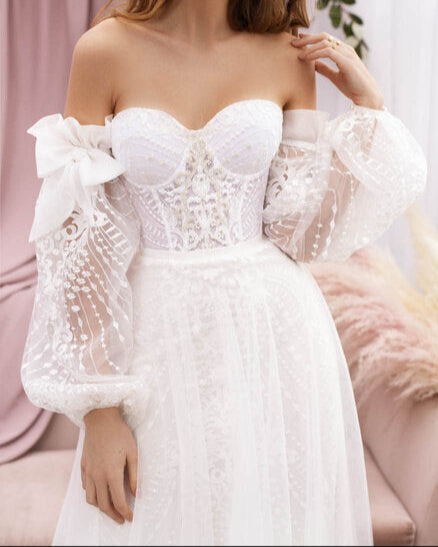 Elegant A-line lace wedding dress with sheer voluminous sleeves for a dreamy effect