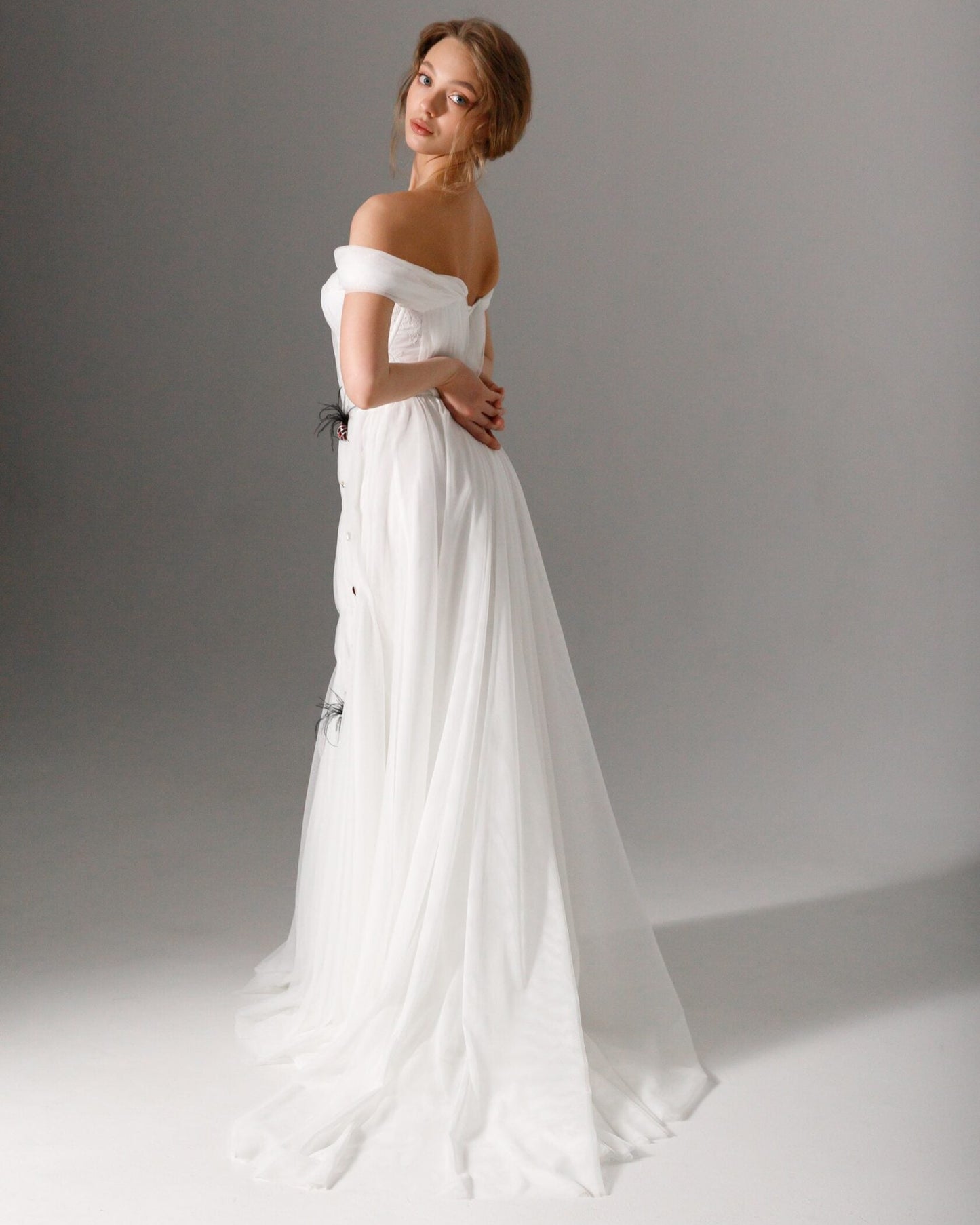 Elegant tulle wedding gown with delicate draping and a structured boned corset