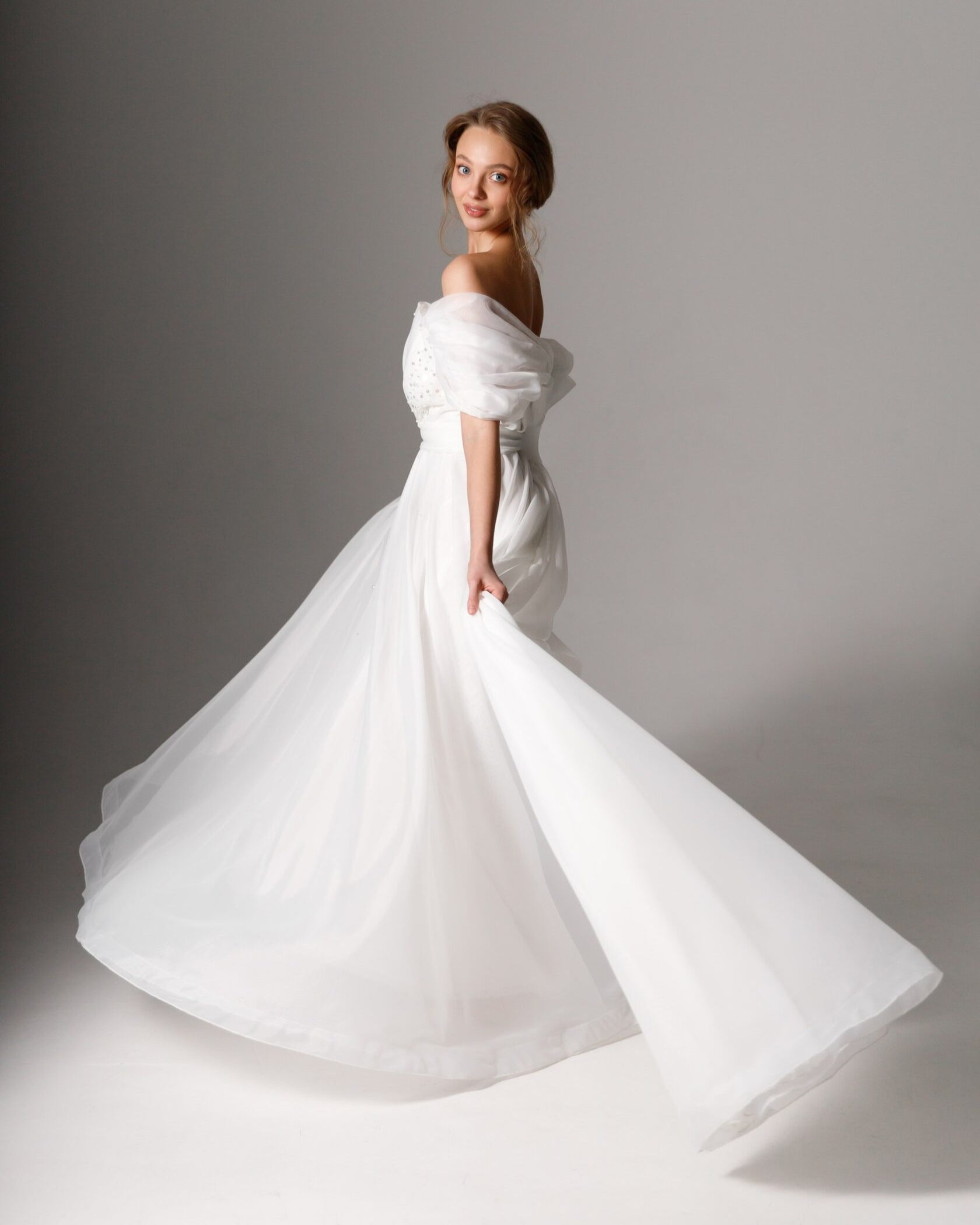 Feminine bridal gown with embellishments featuring hand-sewn pearls and subtle sparkle