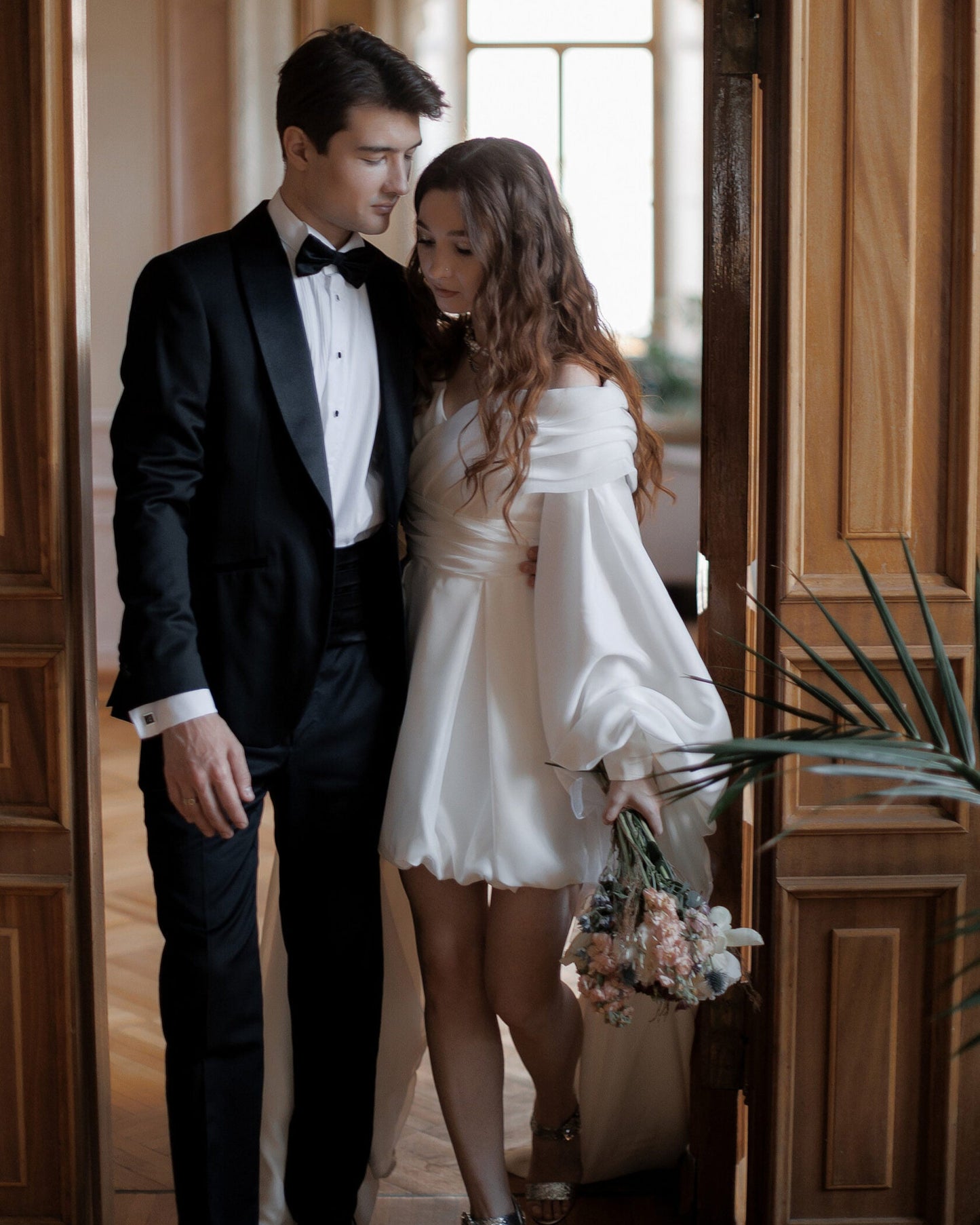 Floor-length sleeve wedding dress with an off-the-shoulder neckline and couture styling