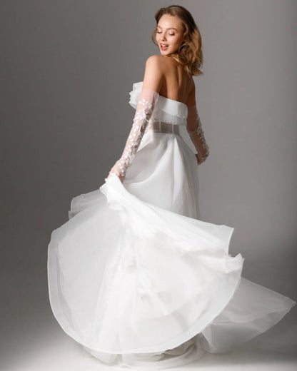 Floral embroidered wedding gown with a soft strapless neckline and an ethereal organza skirt