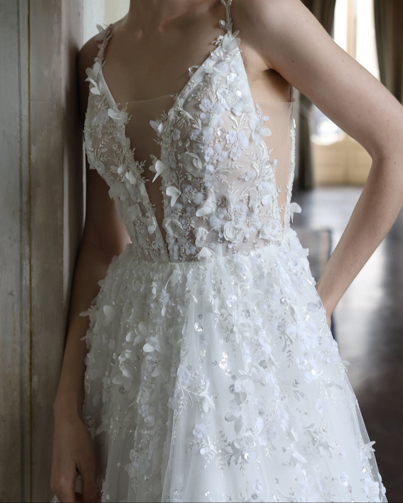 Floral lace A-line wedding dress with a deep V-neckline and shimmering beaded accents