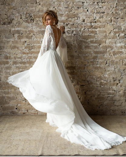 Lace and chiffon wedding dress with a sheer illusion neckline and ethereal movement