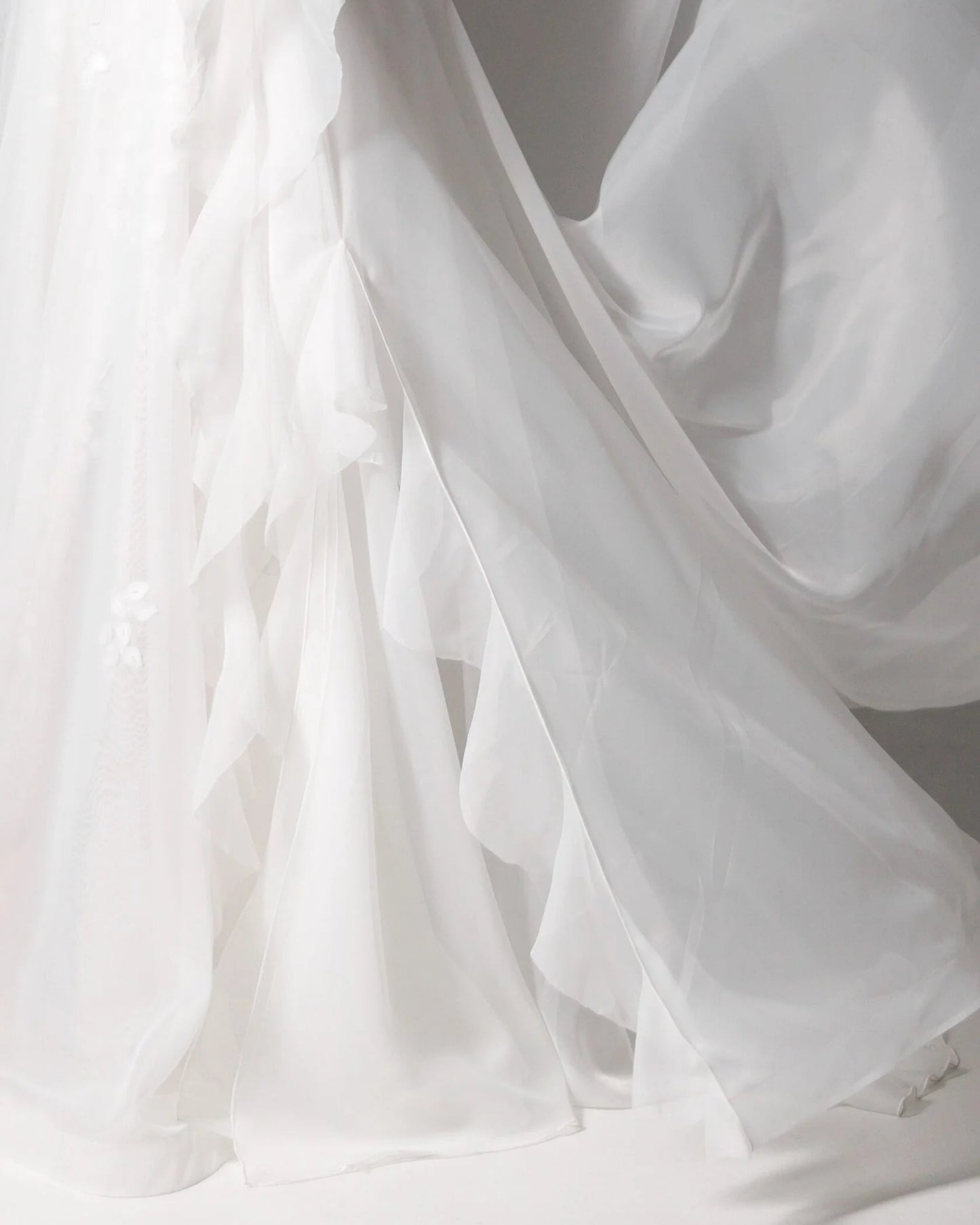 Modern elegance wedding gown with a structured corset top and ethereal ruffled skirt