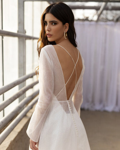 Modern minimalist wedding dress with long sleeves and shimmering tulle overlay