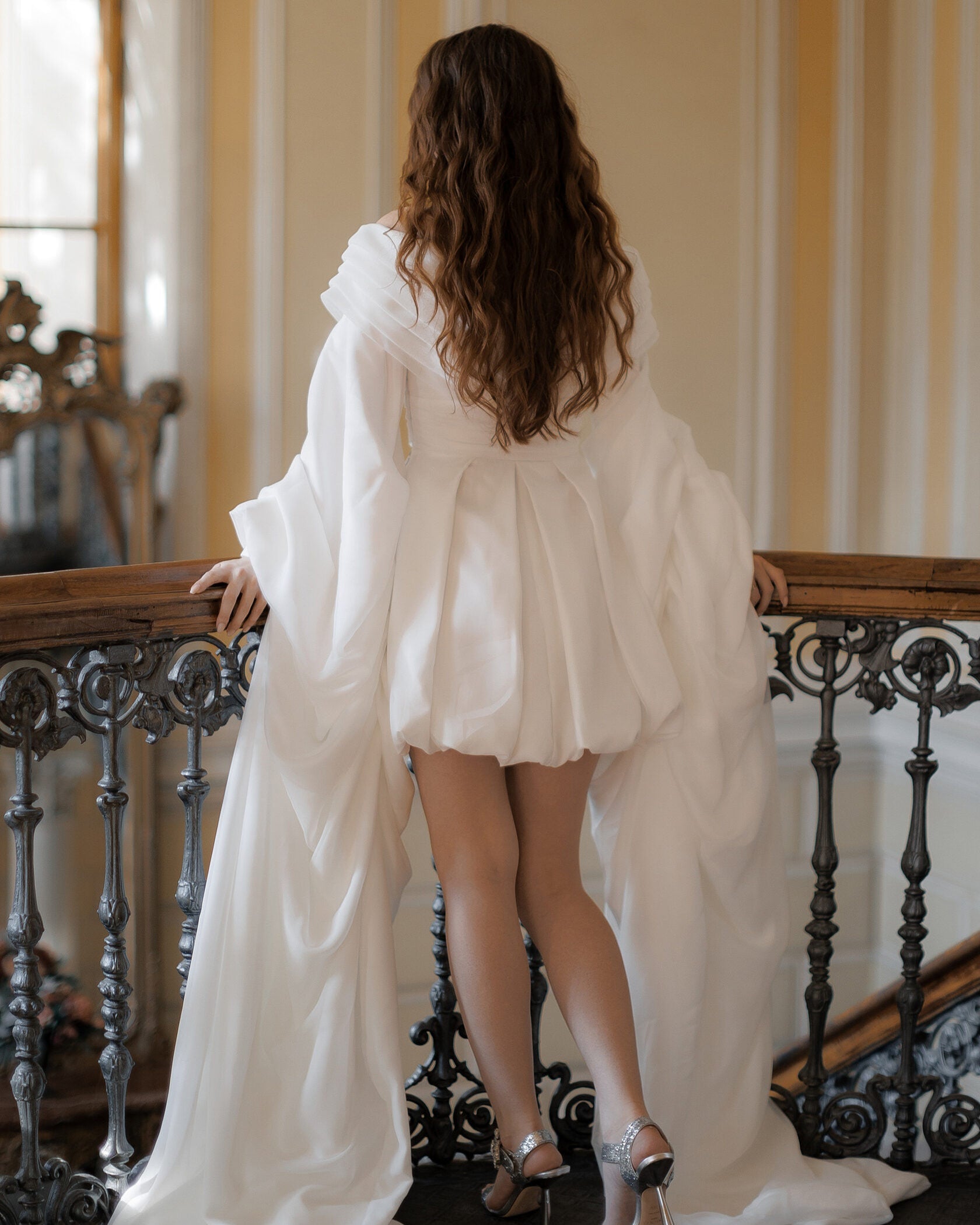 Off-the-shoulder mini bridal dress with voluminous floor-length chiffon sleeves