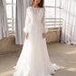 Flowing organza wedding dress with sheer sleeves and a voluminous silhouette