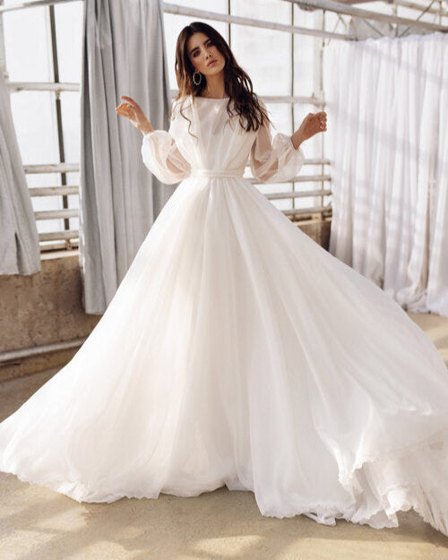 Romantic two-layer wedding gown featuring a satin slip dress and matte organza overlay