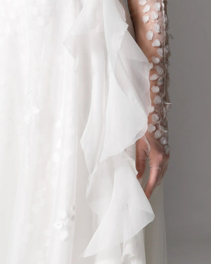 Sheer corset wedding gown with a romantic, airy organza skirt and delicate floral embellishments