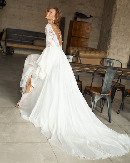 Sheer lace boho bridal gown featuring a soft chiffon overlay and intricate embroidery