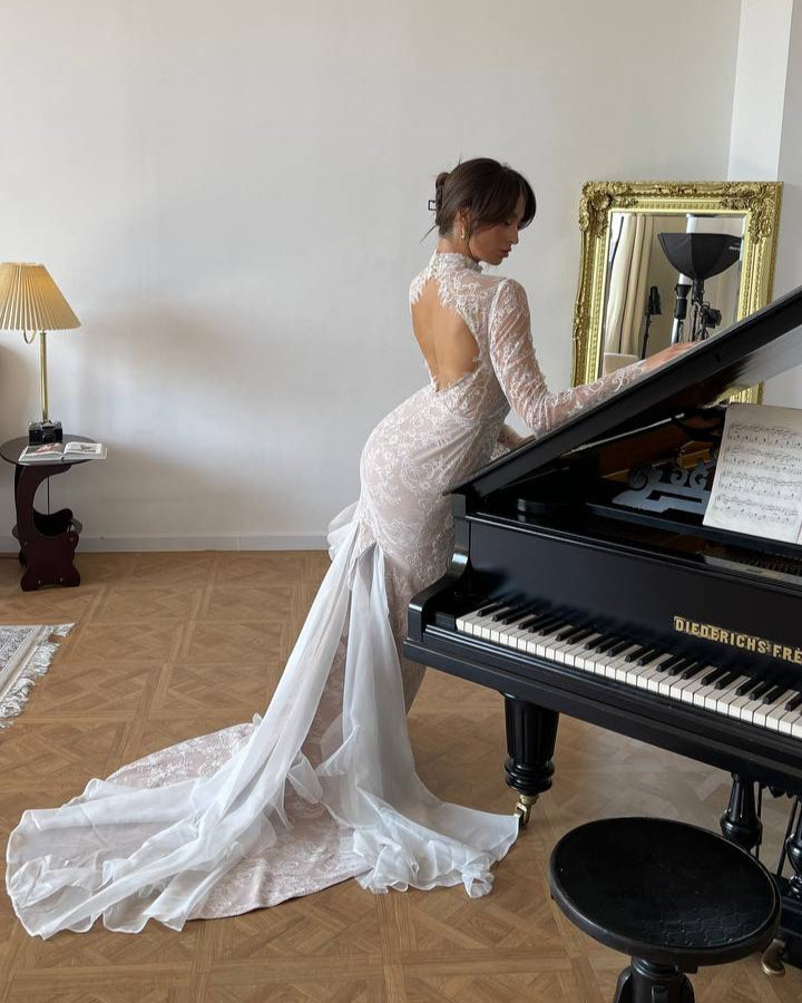 Sheer lace wedding dress with a long chapel train and intricate floral patterns