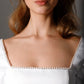 Short satin wedding dress with a voluminous A-line skirt and playful baby doll silhouette
