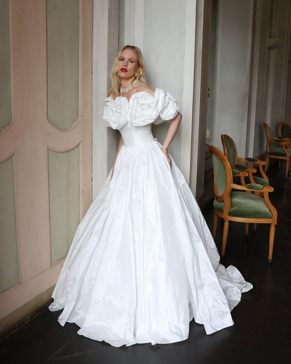 Statement floral embellished wedding dress with sculpted off-shoulder sleeves and a grand skirt