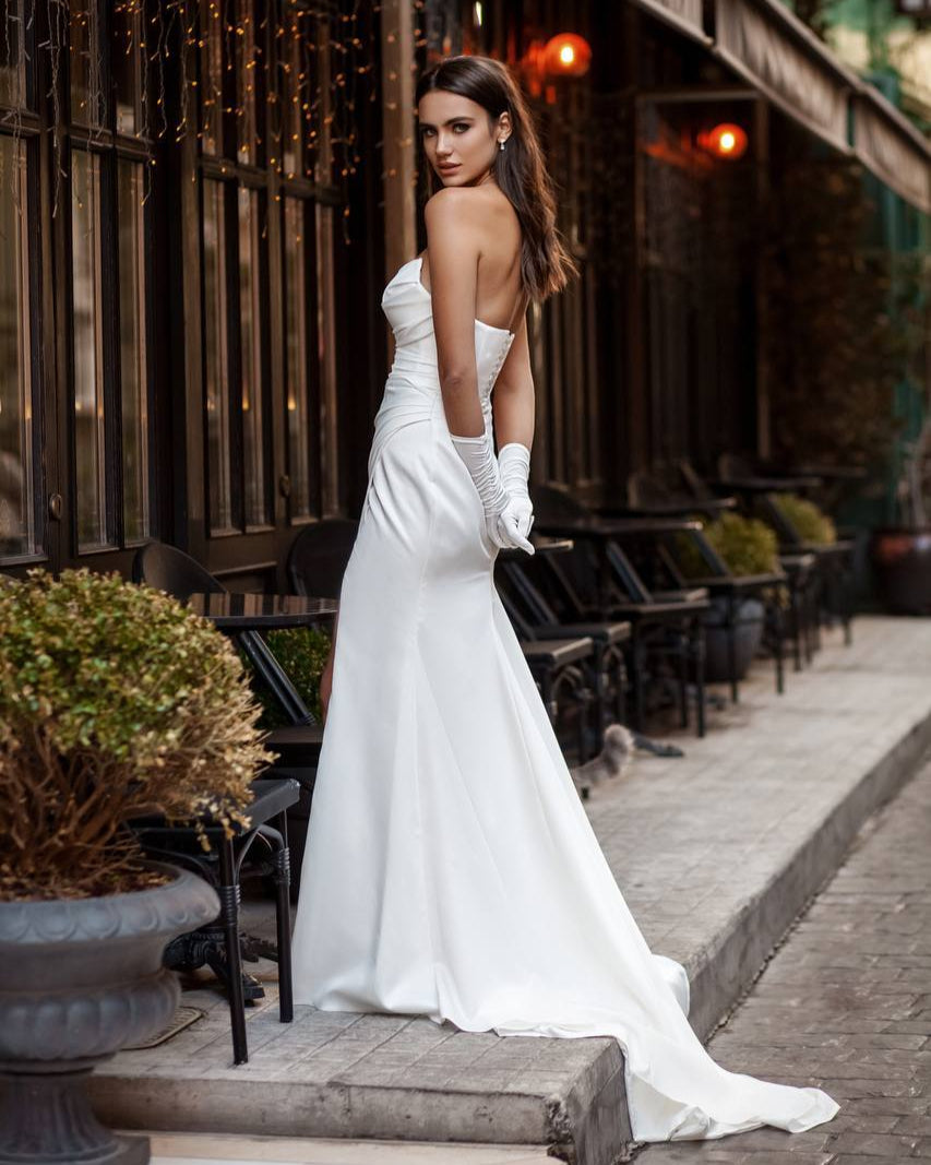 Timeless glamour wedding dress featuring a fitted silhouette and flowing train